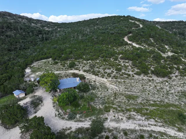 a view of a lush green hillside and a building