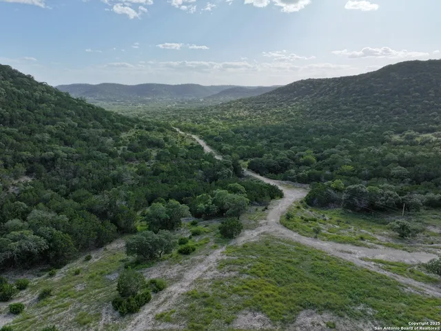a view of a field with an ocean