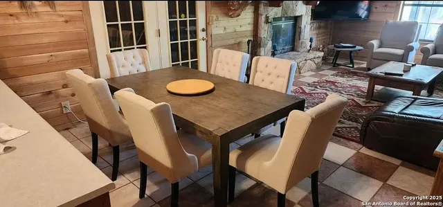a view of a chairs and table in the patio and a fountain