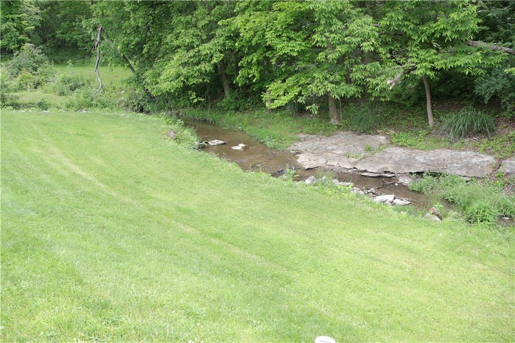 551 Muse-Bishop Road McDonald, PA 15057 - Photo 31 of 38 a backyard of a house with a yard and large trees