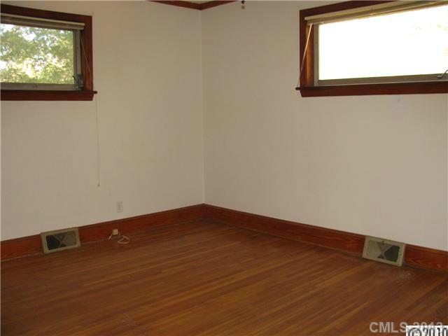 3902 Watson Church Road Monroe, NC 28110 - Photo 7 of 13 an empty room with wooden floor and windows