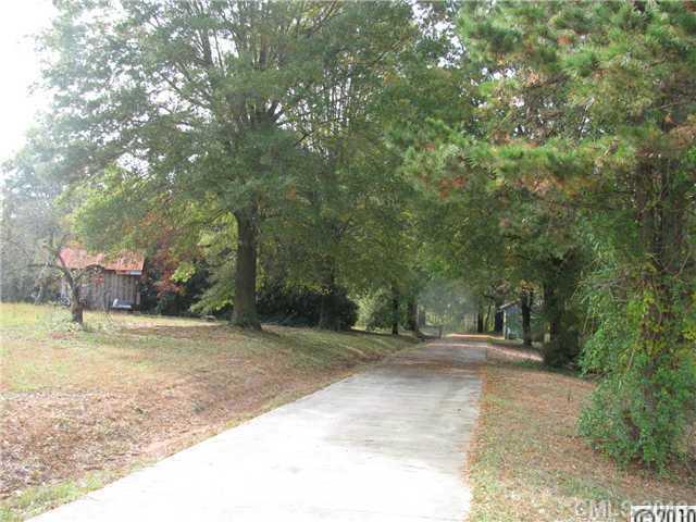 3902 Watson Church Road Monroe, NC 28110 - Photo 9 of 13 a view of a yard with plants and trees