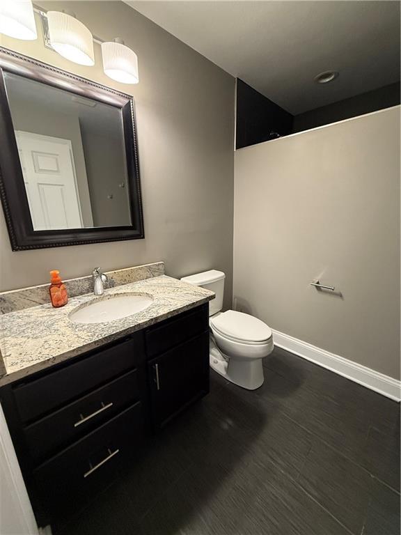 1312 Market Street, Unit 1 Beaver, PA 15009 - Photo 14 of 17 a bathroom with a granite countertop sink a toilet and a mirror