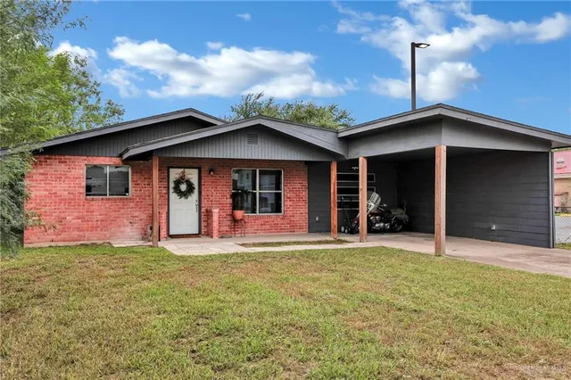 a view of a house with a yard and garage