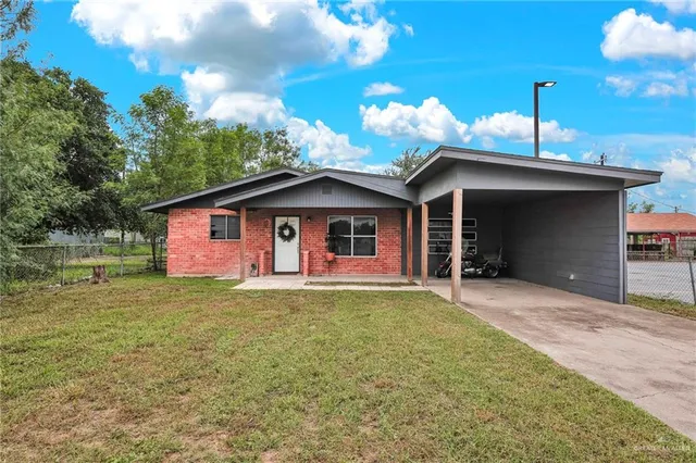 a front view of a house with yard