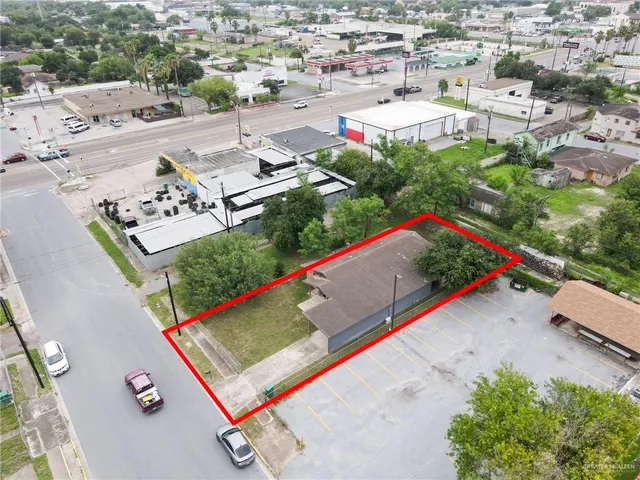 an aerial view of a pool a yard and mountain