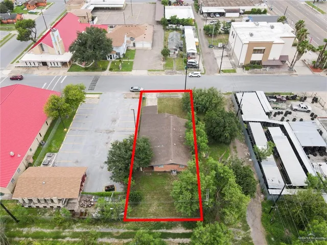 a aerial view of a house with a yard and potted plants