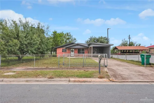 a front view of a house with a yard table and chairs