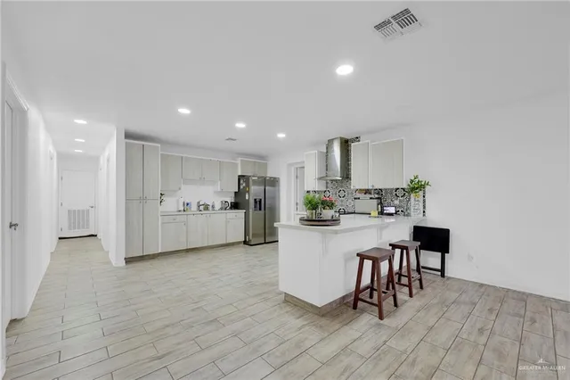 a view of kitchen with furniture and refrigerator