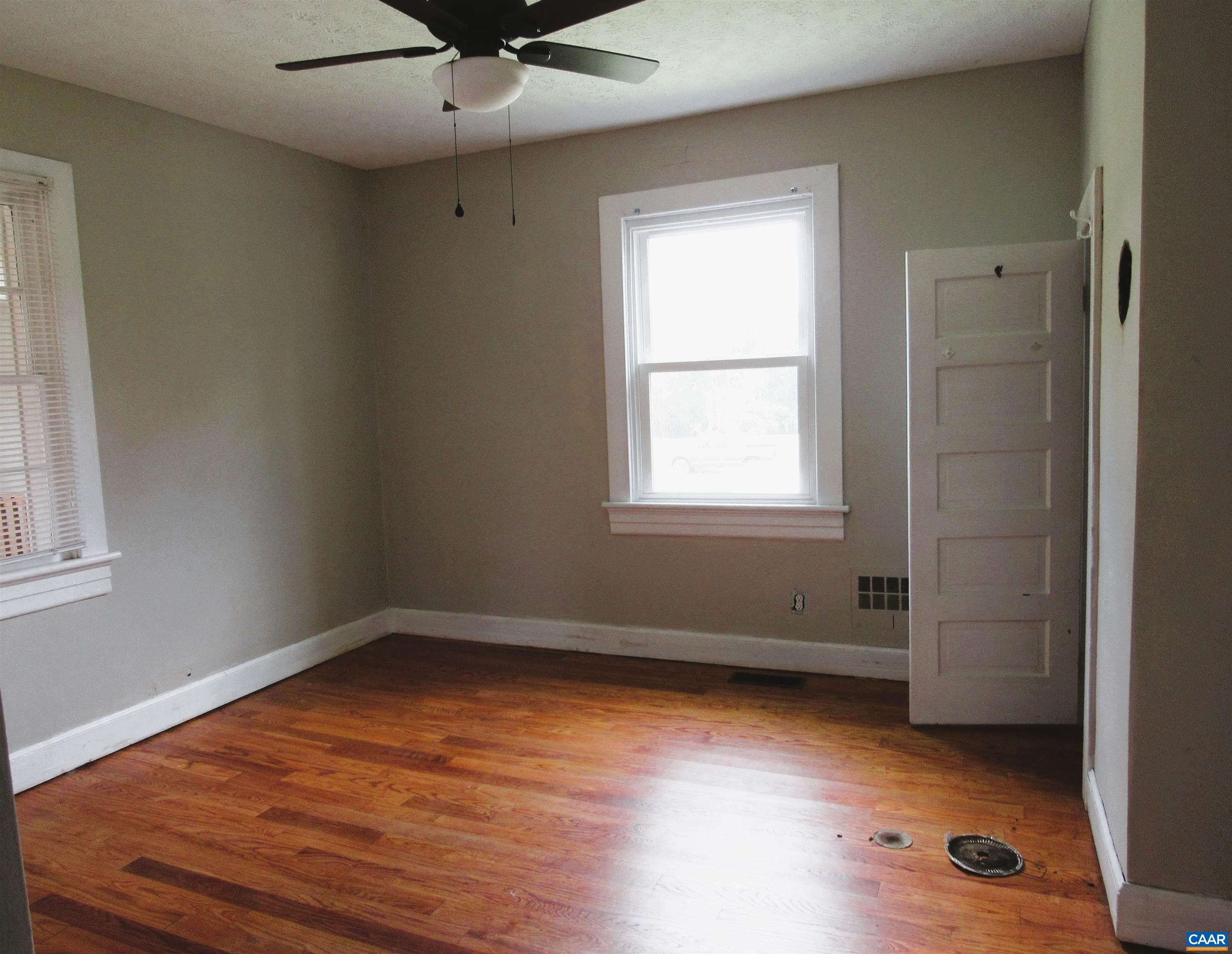 1358 South Coolwell Road Madison Heights, VA 24572 - Photo 11 of 27 an empty room with wooden floor and windows