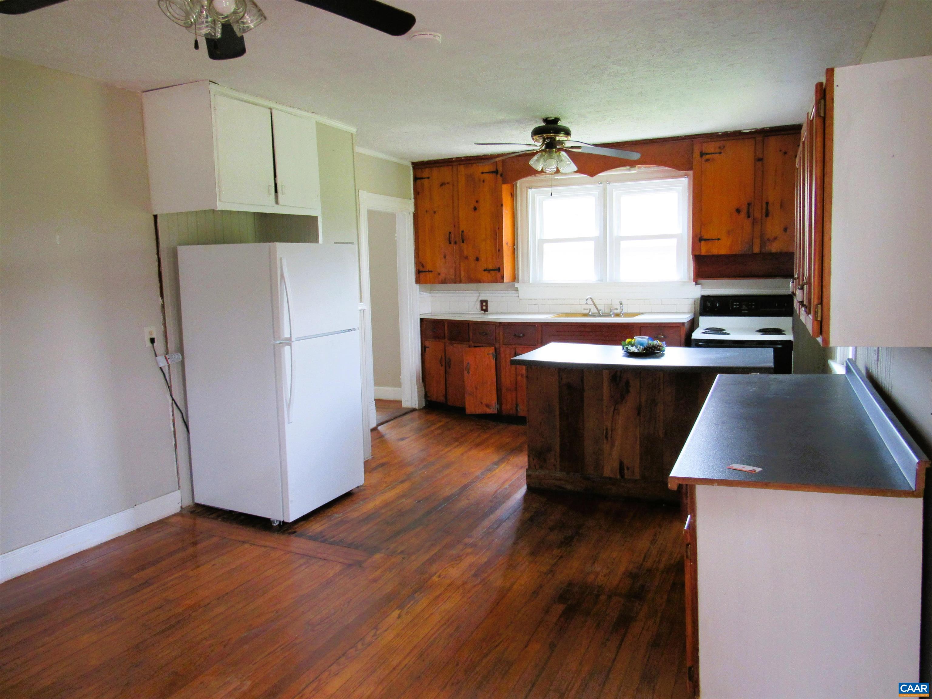 1358 South Coolwell Road Madison Heights, VA 24572 - Photo 7 of 27 a kitchen with wooden floors and white stainless steel appliances