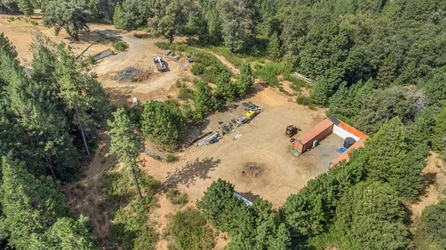 an aerial view of house with yard and swimming pool