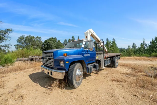 a car parked in front of a house with a big yard