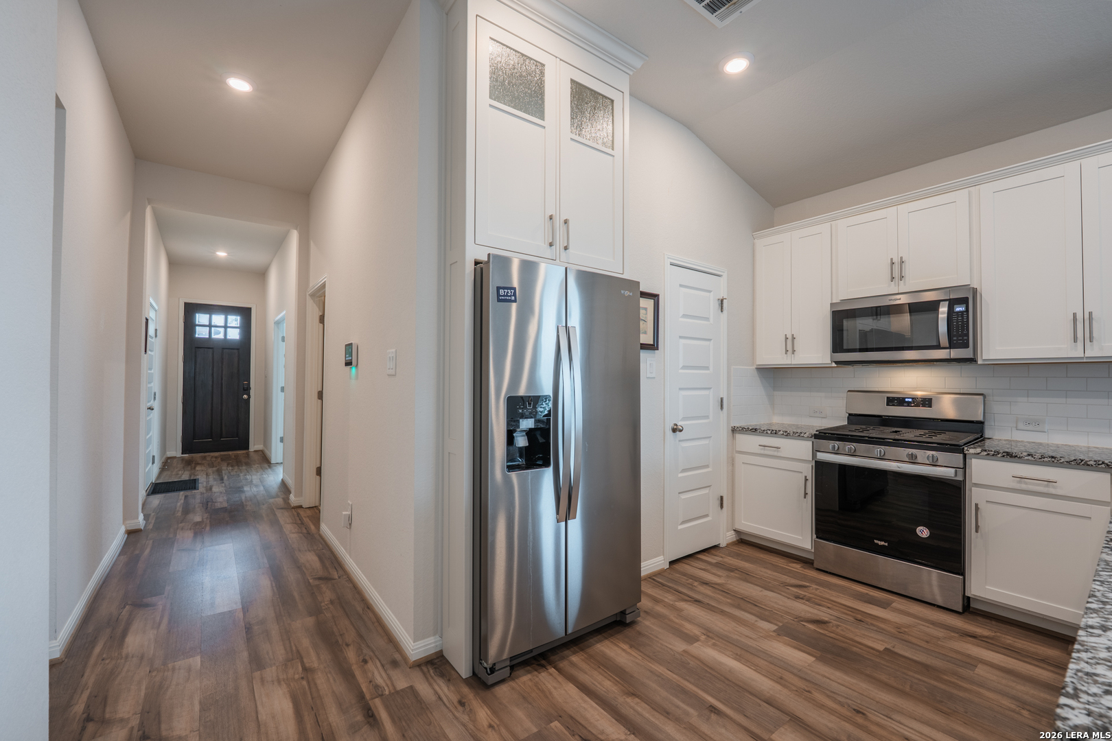 4947 Ranahan Pass St. Hedwig, TX 78152 - Photo 5 of 37 a kitchen with stainless steel appliances a refrigerator stove and microwave