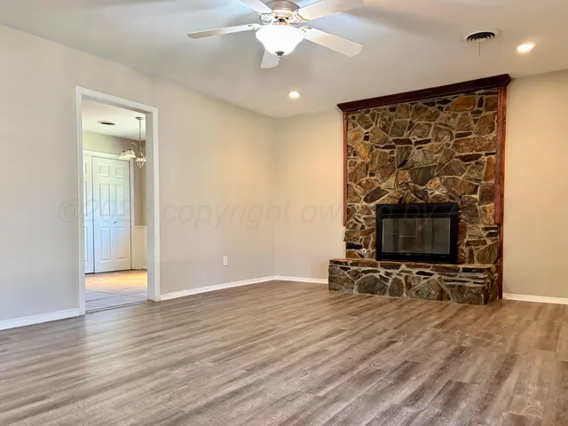 a kitchen with granite countertop a stove top oven cabinetry a sink and a counter