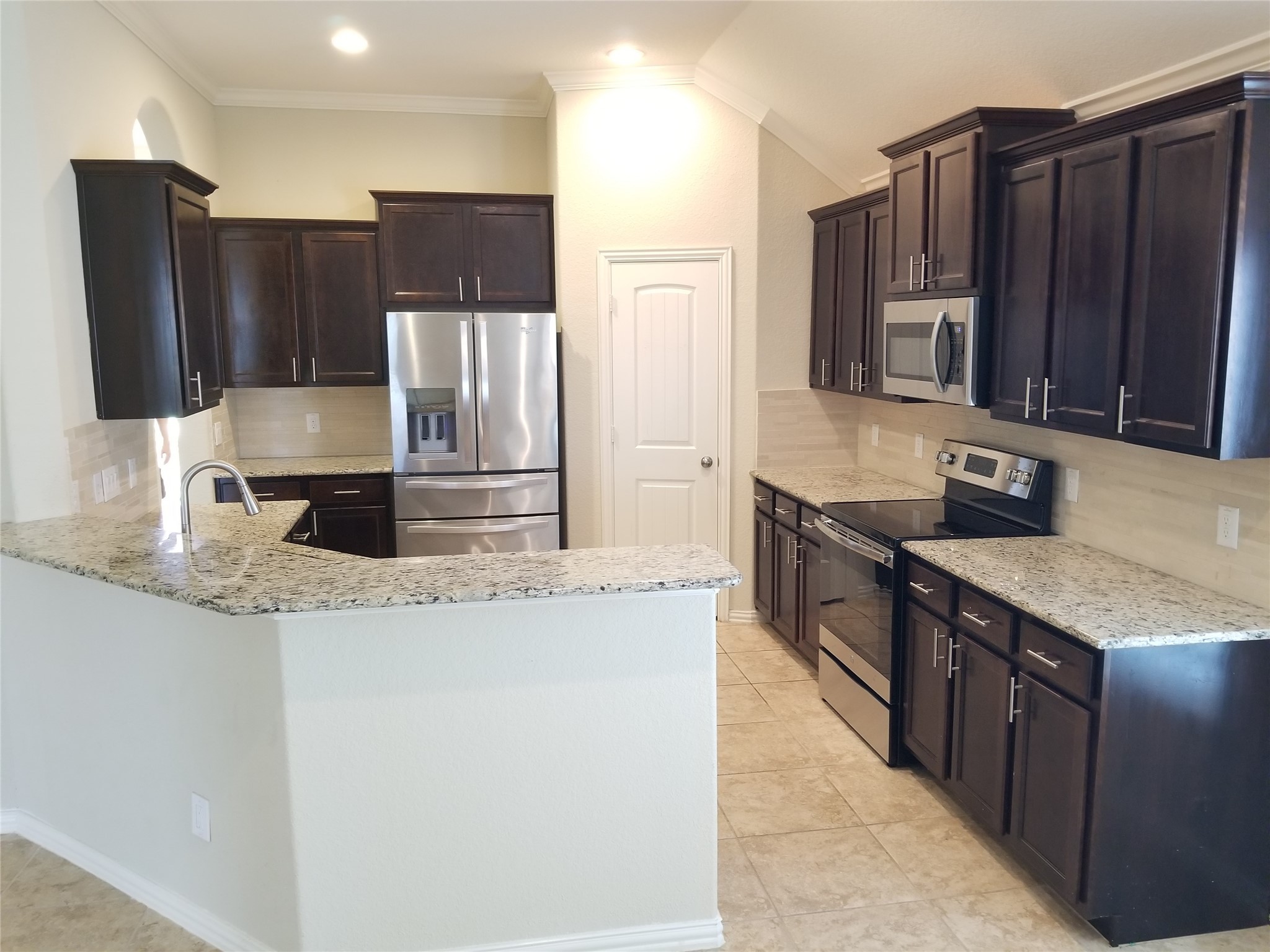 5217 Green Heath Lane Rosharon, TX 77583 - Photo 5 of 18 a kitchen with stainless steel appliances granite countertop a refrigerator and a sink