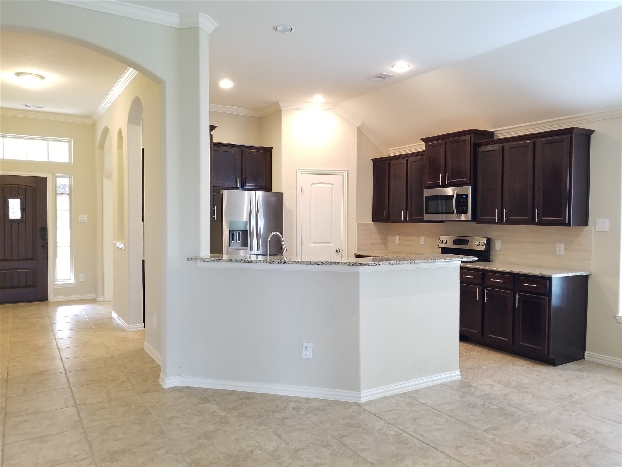 5217 Green Heath Lane Rosharon, TX 77583 - Photo 7 of 18 a kitchen with stainless steel appliances granite countertop a refrigerator and a stove top oven