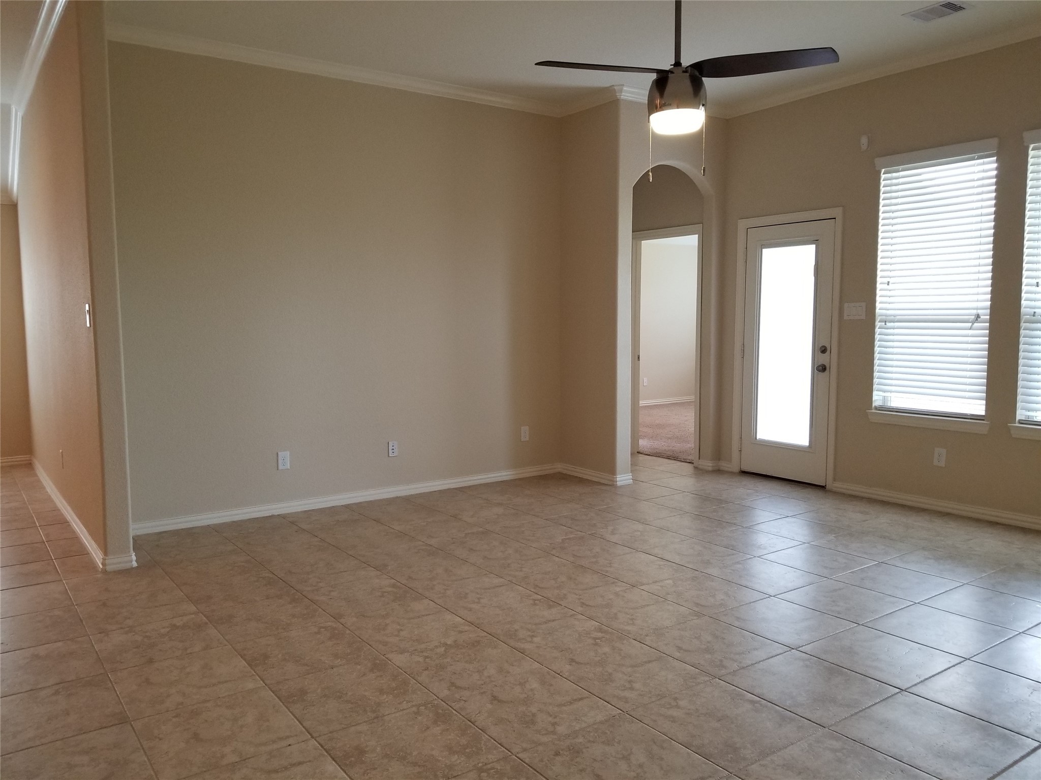 5217 Green Heath Lane Rosharon, TX 77583 - Photo 9 of 18 an empty room with chandelier fan and windows