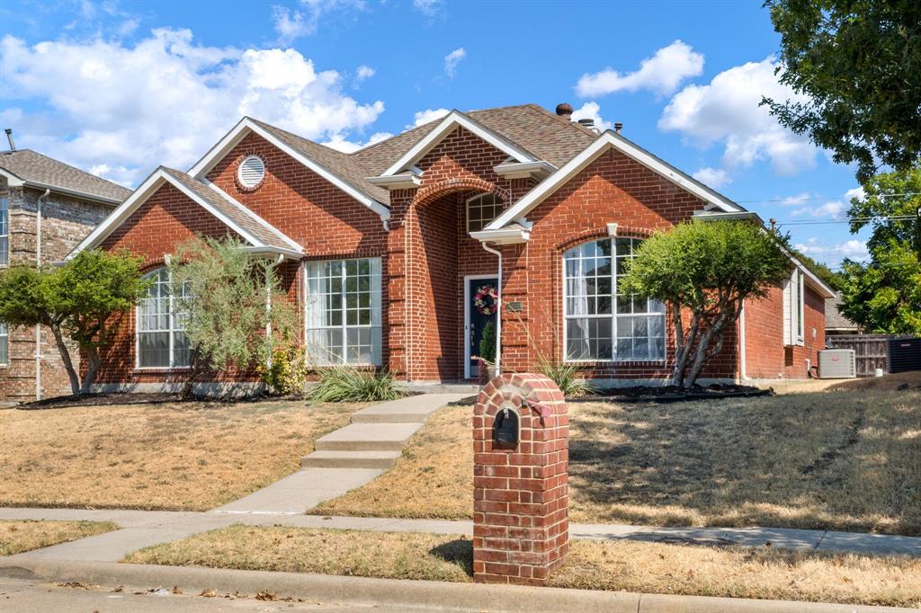11414 Promenade Road Frisco, TX 75035 - Photo 24 of 24 Brick exterior with a gabled roofline, arched entry, and prominent bay windows