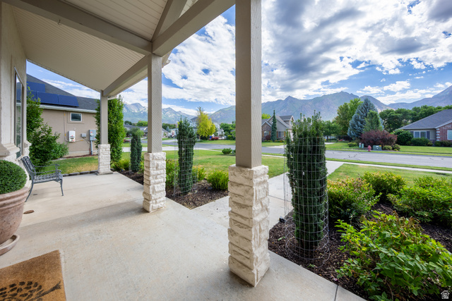 868 Braddock Lane Alpine, UT 84004 - Photo 5 of 64 Covered front porch featuring stacked stone columns and a concrete surface