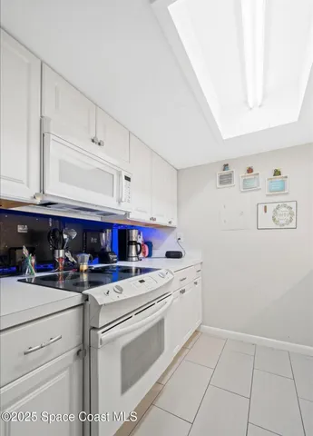 a kitchen with a stove top oven and cabinets