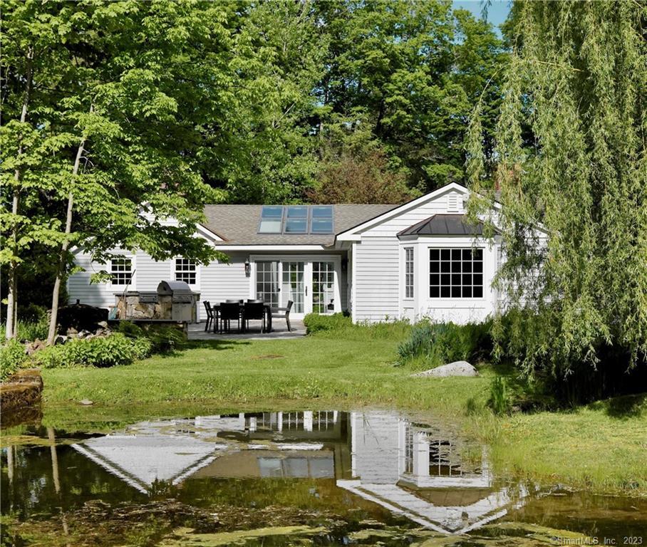 90 Sharon Mountain Road Sharon, CT 06069 - Photo 2 of 23 a front view of a house with a garden