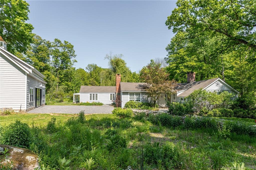 90 Sharon Mountain Road Sharon, CT 06069 - Photo 21 of 23 a front view of a house with a yard and trees