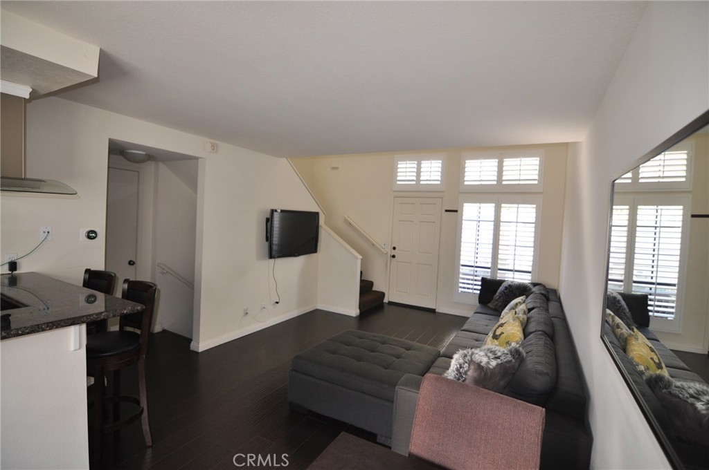249 Alpine Street, Unit 48 Pasadena, CA 91106 - Photo 4 of 14 a living room with furniture and a flat screen tv