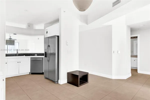 a kitchen with stainless steel appliances a refrigerator and cabinets