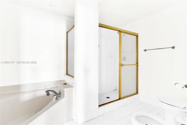 a large bathroom with a tub and sink
