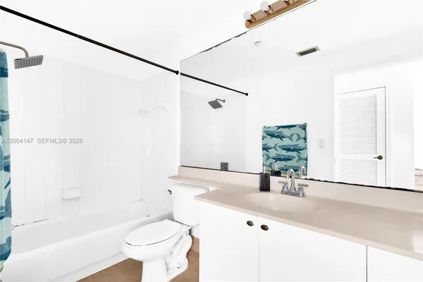 a view of a room with a ceiling fan and a window