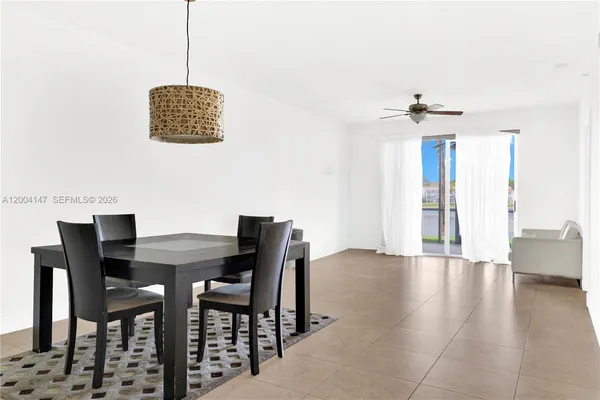 a dining room with furniture and a chandelier