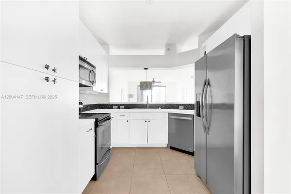 a kitchen with stainless steel appliances a refrigerator sink and stove