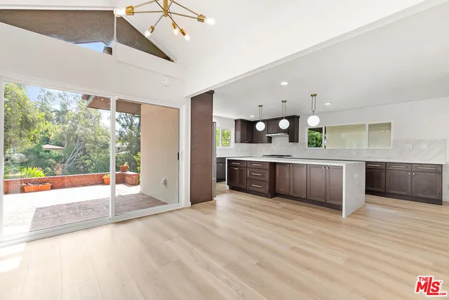 a large kitchen with stainless steel appliances double vanity and a large window