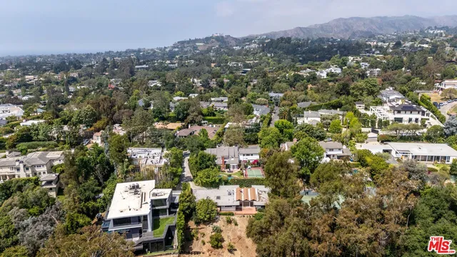 an aerial view of residential houses with city view