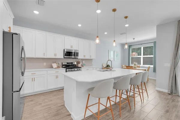 a kitchen with stainless steel appliances kitchen island granite countertop a sink and cabinets