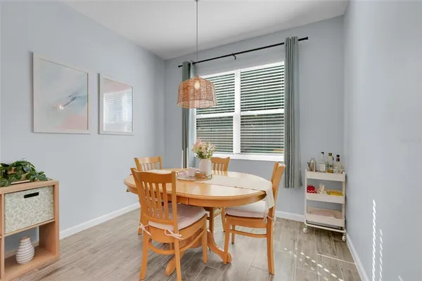 a dining room with furniture and window