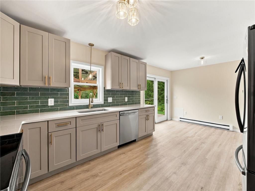90 Gun Club Road Palmerton, PA 18071 - Photo 32 of 58 Gleaming stone countertops and modern shaker cabinetry frame a bright culinary workspace.