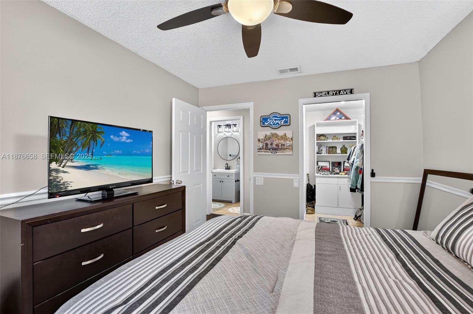 21707 Cromwell Circle Boca Raton, FL 33486 - Photo 54 of 75 a bedroom with a bed and a flat screen tv
