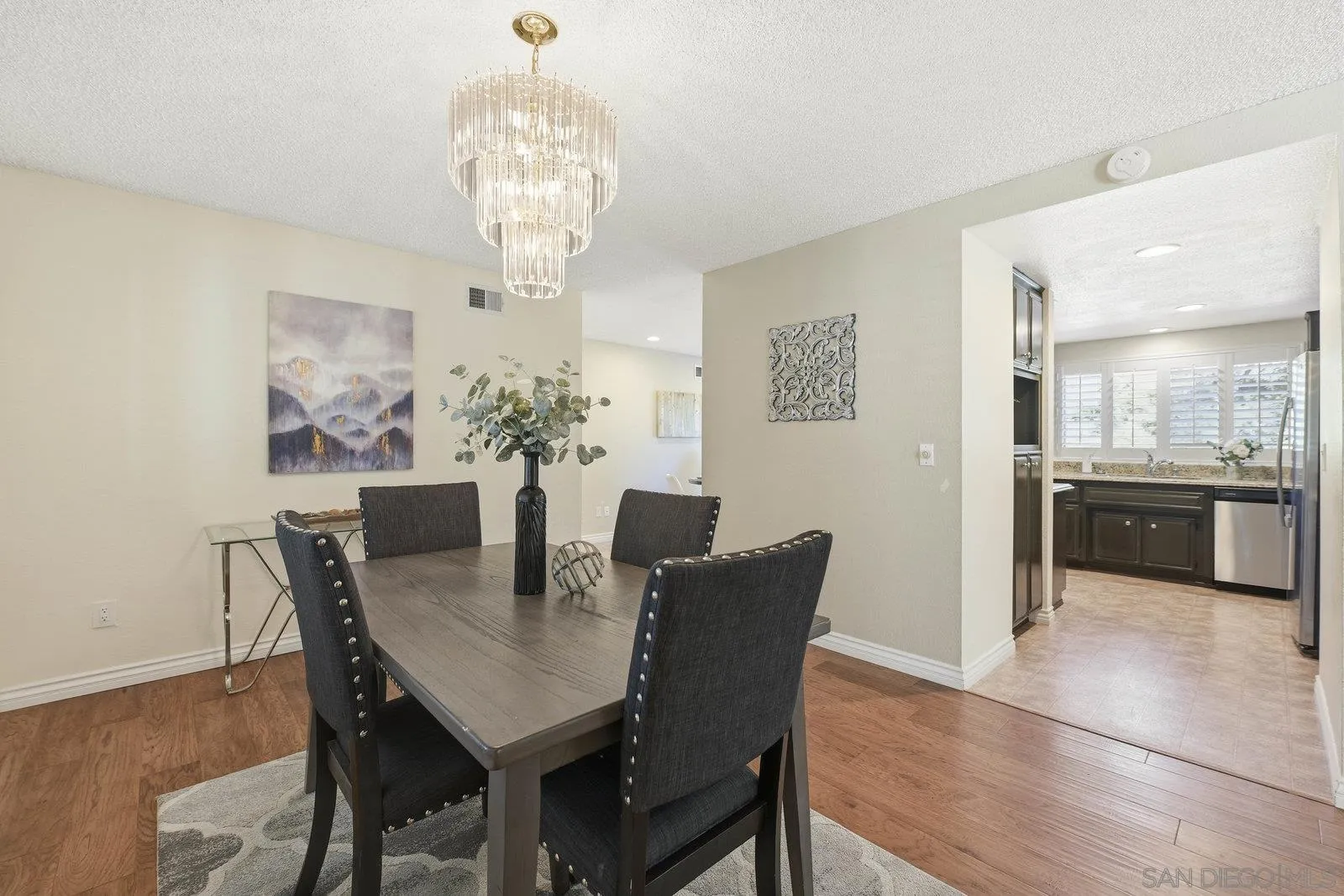 16120 Poderio Court Ramona, CA 92065 - Photo 16 of 38 a view of a dining room with furniture a chandelier and wooden floor