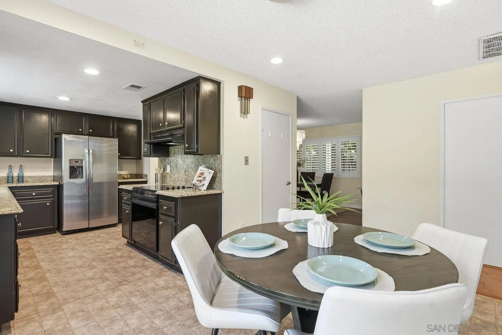 16120 Poderio Court Ramona, CA 92065 - Photo 20 of 38 a kitchen with refrigerator and chairs