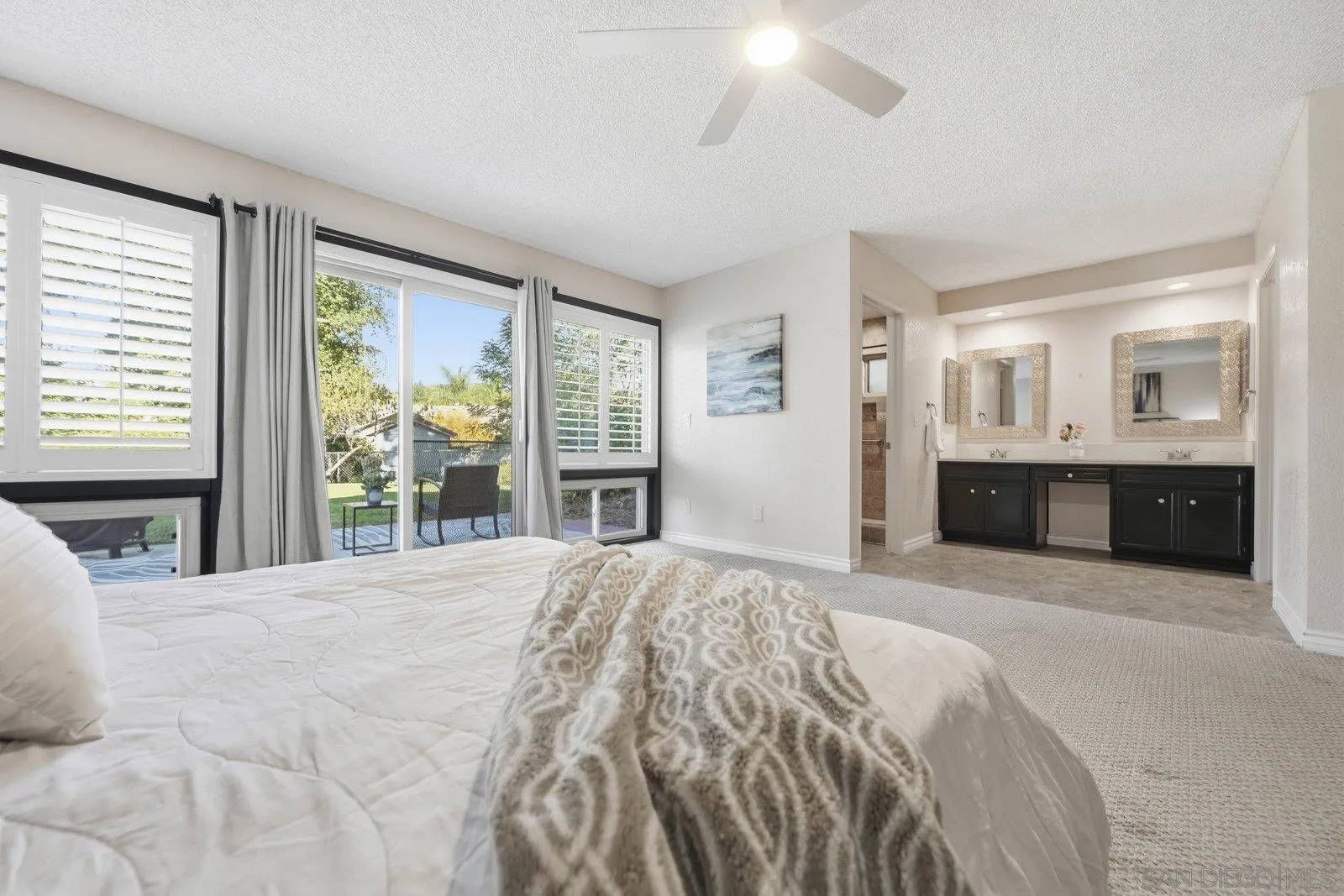 16120 Poderio Court Ramona, CA 92065 - Photo 24 of 38 a large bedroom with a large bed and a large window