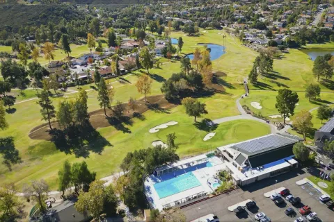 an aerial view of residential houses with outdoor space