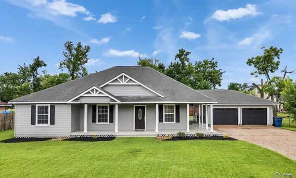 a front view of a house with a garden