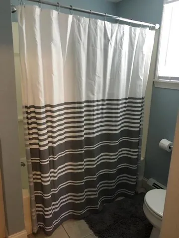 a bathroom with a sink toilet and a mirror