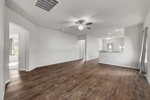 a view of an empty room with a kitchen