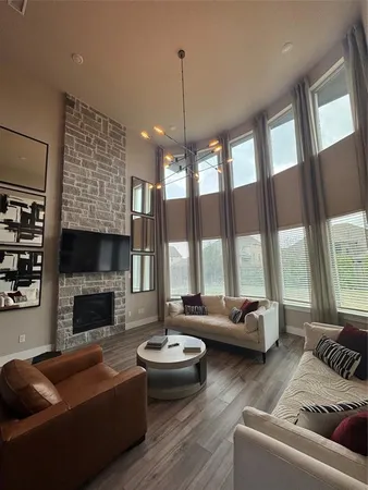 a living room with patio furniture and a large window