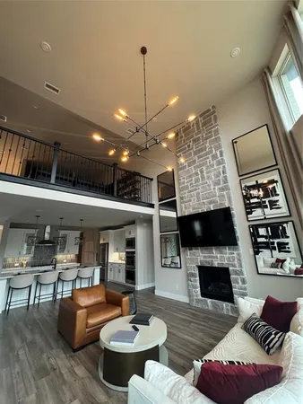 a living room with furniture fireplace and large windows