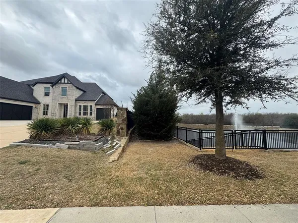 a view of house with yard and sitting area