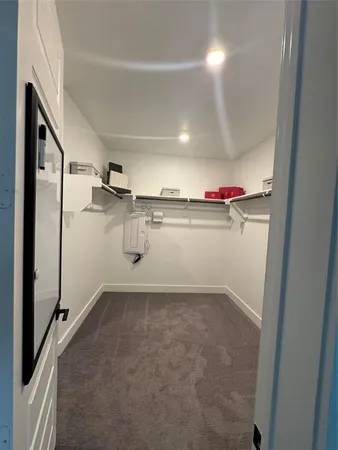a large white kitchen with a large window and stainless steel appliances